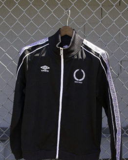 Black track jacket on fence