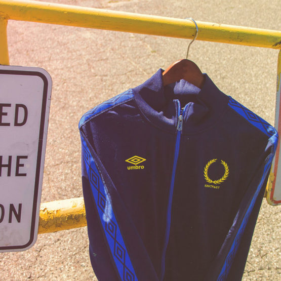 blue track jacket on yellow post
