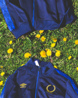blue track jacket on grass