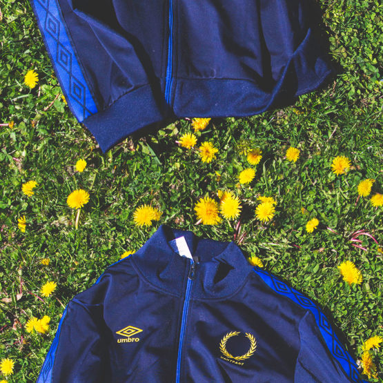 blue track jacket on grass