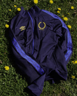 blue track jacket on grass