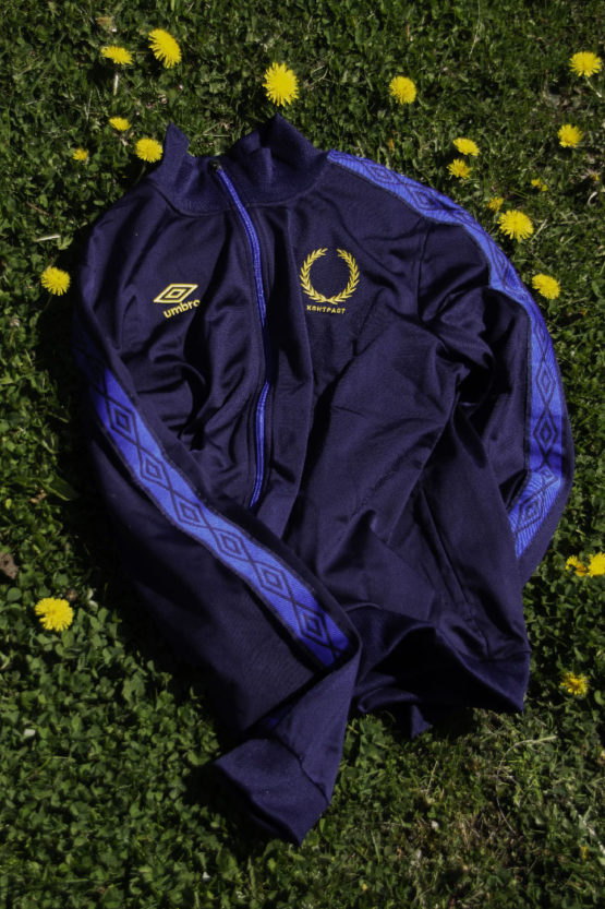 blue track jacket on grass